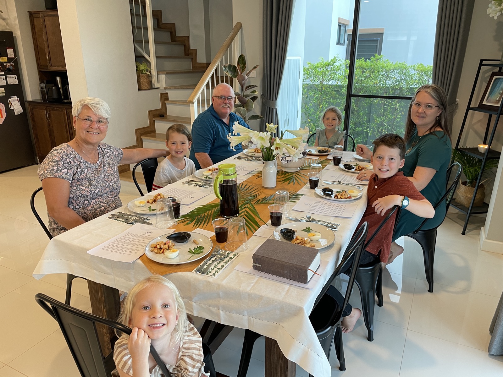Three generations of the Derington family gathered around a table in Thailand
